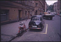 Kungstensgatan västerut mot Sveavägen vid Luntmakargatan. Bil av modellen Austin 80 och en moped parkerad utanför Kungstensgatan 31.