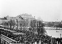 Den politiska storstrejkens första dag på Norrbro den 15 maj år 1902. I mitten bland de strejkande går vaktparaden. I bakgrunden Operahuset.