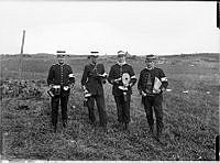 Fältmanöver 1910 i trakterna kring Ölsta gård nära Märsta och Sigtuna.
Fyra soldater under en matrast.