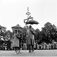 Regn och kyla på midsommar. På väg hem i regnet från midsommarfirandet och dansandet på Bollnästorget på Skansen.