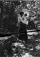 Maria Johansson står på en skogsstig med dottern Dagny på armen.