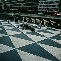 Facklor, bodar och julgranar på Sergels Torg. Vy mot Åhléns.