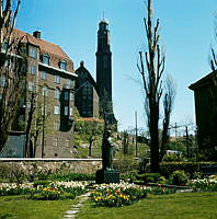 Borgarskolans park (nuv. Ellen Keys Park) med blommor kring Sigrid Fridmans skulptur av Ellen Key. Vy åt öster mot Engelbrektskyrkan.