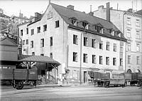 Källaren Lokatten i Stadsgården. Tv. går Lokattens Trappor till Stora  Glasbruksgatan. Godsvagnar i förgrunden.