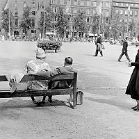 Kungsträdgården mot öster, Kungsträdgårdsgatan. I förgrunden ett äldre par på parkbänk.