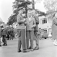 Skolavslutning. Pojkar i kostym på skolgård vid Enskedefältets skola.