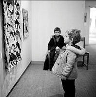 Liten pojke betraktar textilt verk på utställning i Moderna museet.