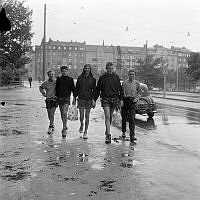 Djurgårdsvägen mot Strandvägen 49-57. Tyska ungdomar på besök i Stockholm vandrar i regnet.