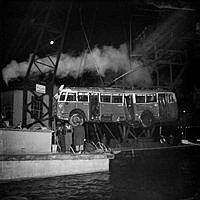 Trådbuss på linje 96 bärgas ur vattnet med pontonkran efter olycka. Bussen krockade med en lastbil på stora Essingebron, Bussen störtade genom broräcket. (Av 12 personer överlever 1). 

